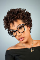 Woman wearing black cat-eye glasses with a blurred background, Obroi