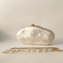 White clutch bag with gold chain on a light gray background, Obroi
