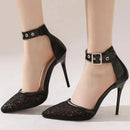 Black high-heeled shoes with lace detailing and buckles on a neutral background, Obroi