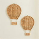 Two woven wicker hot air balloon wall hangings in a natural light tan color, displayed against a plain off-white wall, Obroi