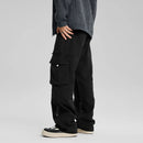 Person wearing black cargo pants on a gray background, Obroi