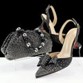 Black high-heeled shoes with bow detail and matching handbag on a white background, featuring the brand 'Obroi'.