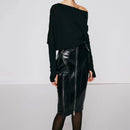 Person wearing a black off-shoulder top and black leather skirt on a light gray background ,Obroi