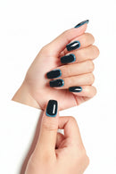 Hand with black and blue nail polish holding a magazine, Obroi