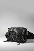 A tactical crossbody bag with a black, green, and beige camouflage pattern, featuring a prominent black honeycomb-textured front flap and an adjustable black shoulder strap, shown on a light gray background, Obroi