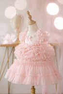 Pink ruffled dress on a mannequin against a soft pink background, Obroi