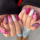 Close-up of hands with pink and white striped nail art on a blurred background, Obroi