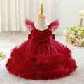 Red tulle dress on a mannequin with a soft white background, Obroi