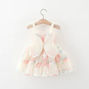 Floral dress on a hanger against a white background, Obroi