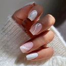 Close-up of a hand with pink and white nail polish on a neutral background,Obroi