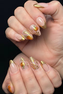 Nails with pumpkin and leaf designs on a neutral background, Obroi