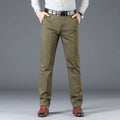 Person wearing olive green pants with a gray background, Obroi