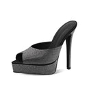 Black high-heeled shoe with rhinestone embellishments on a white background, Obroi