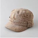 Beige distressed cap with embellishments on a light gray background, Obroi