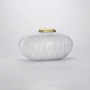 White textured vase with a gold lid on a light gray background, Obroi
