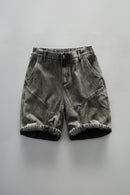 Black denim shorts on a gray background, Obroi
