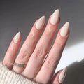 Hand with beige nail polish on a neutral background, Obroi