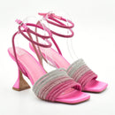 Pink high-heeled sandals with rhinestone detailing on a white background, Obroi