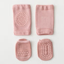 Set of four pink baby socks with textured patterns on a light gray background, Obroi