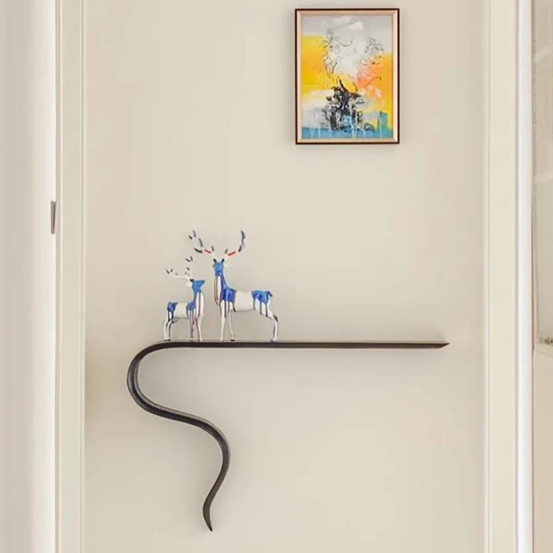 Modern wall-mounted console table with decorative deer figurines against a light wall with a colorful abstract painting, Obroi