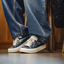Close-up of blue jeans and white sneakers on a blurred background, Obroi