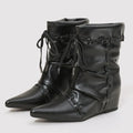 Black leather boots with tie details on a light gray background, Obroi