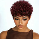 Woman with burgundy curly hair wearing a brown top on a white background, Obroi