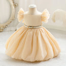 Beige dress on a mannequin with a decorative background, Obroi