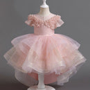 Pink children's dress on a mannequin against a dark background, Obroi