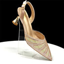 Gold high-heeled shoe with intricate design on a clear stand against a black background, Obroi