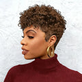 Woman with short, curly hair wearing a maroon turtleneck against a textured white background, Obroi