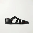 Black sandal with strap design on a light gray background