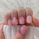 Hand with pink marble nails with gold accents on a white textured background, Obroi