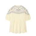 Cream-colored blouse with intricate embroidery on a white background, Obroi