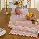 Decorative table setting with pink table runner and napkins on a wooden table, Obroi