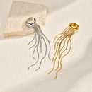 Silver and gold rings with long chains on a textured beige surface, Obroi