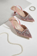 Pink embellished high heels on a light background, Obroi