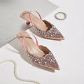 Pink embellished high heels on a light background, Obroi