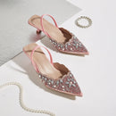 Pink embellished high heels on a light background, Obroi