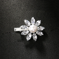 Jewelry clip with a pearl and crystal stones on a black background, Obroi