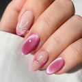Obroi Close-up of a hand with pink nail polish and small crystals on a light background