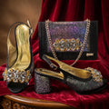 Black high-heeled shoes with crystal embellishments and a matching handbag on a red fabric background, Obroi