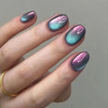Hand with multicolored metallic nail polish on a plain background, Obroi