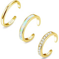 Three gold open rings with different designs on a white background, Obroi