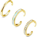Three gold open rings with different designs on a white background, Obroi