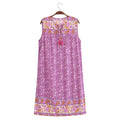 A sleeveless purple floral print nightgown with embroidered borders and a drawstring tie at the neckline, hanging on a wooden hanger against a white background, Obroi