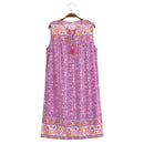 A sleeveless purple floral print nightgown with embroidered borders and a drawstring tie at the neckline, hanging on a wooden hanger against a white background, Obroi