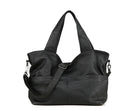 Black leather handbag with a shoulder strap on a white background, Obroi