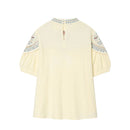 Light yellow blouse with embroidered sleeves on a white background, Obroi