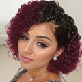 Woman with a stylish haircut featuring purple and black hair, wearing a necklace and earrings, Obroi